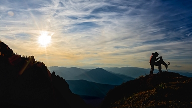 Person with a dog on a mountain