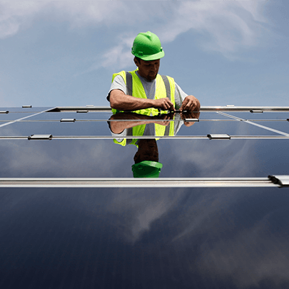 A Mars Associate wearing safety gear working on solar panels